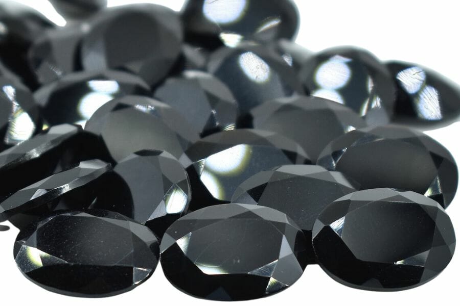 A pile of several cut dark black onyx stones