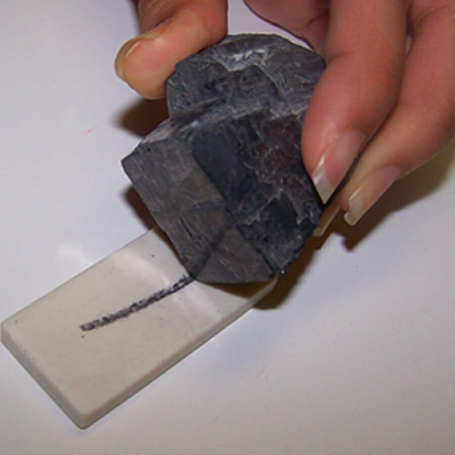 A specimen scratched against a streak plate leaves a black streak