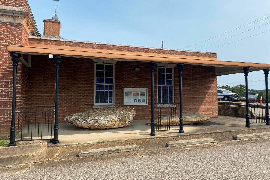 porch at the Tennessee River Museum displaying two large petrified logs