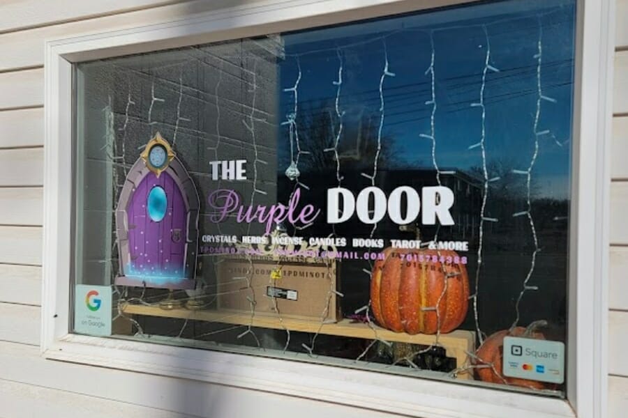 A look at the front shop window of The Purple Door
