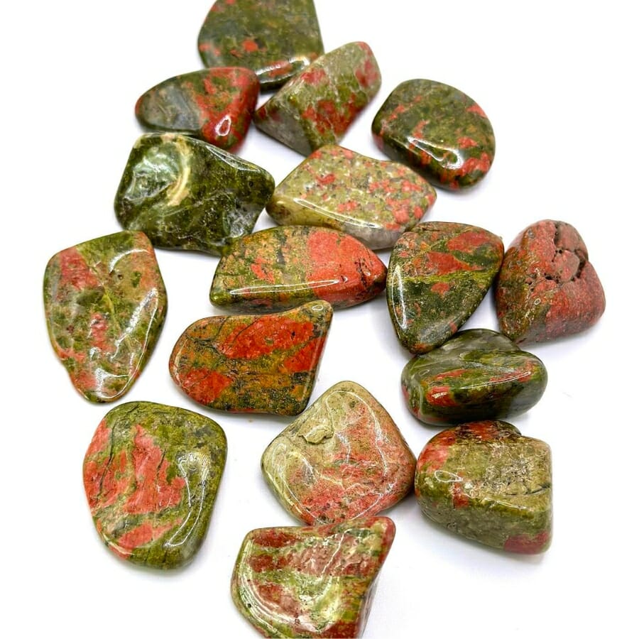 Polished unakite stones with a mix of green and pink hues