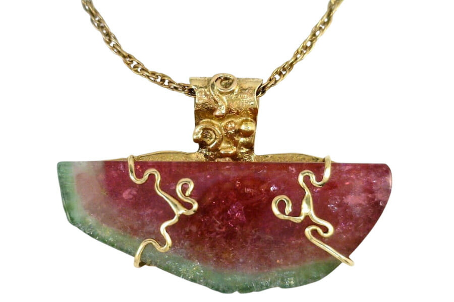An elegant handmade watermelon tourmaline necklace with intricate gold details