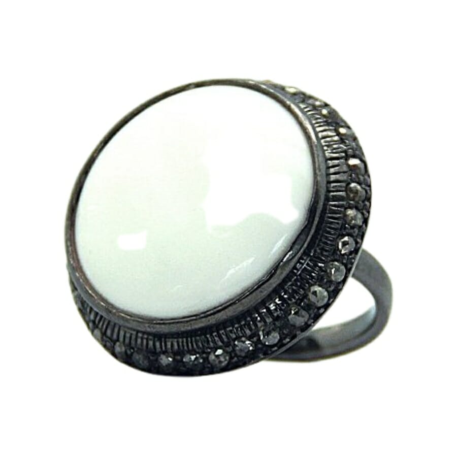 An elegant vintage-looking white onyx ring with intricate detail