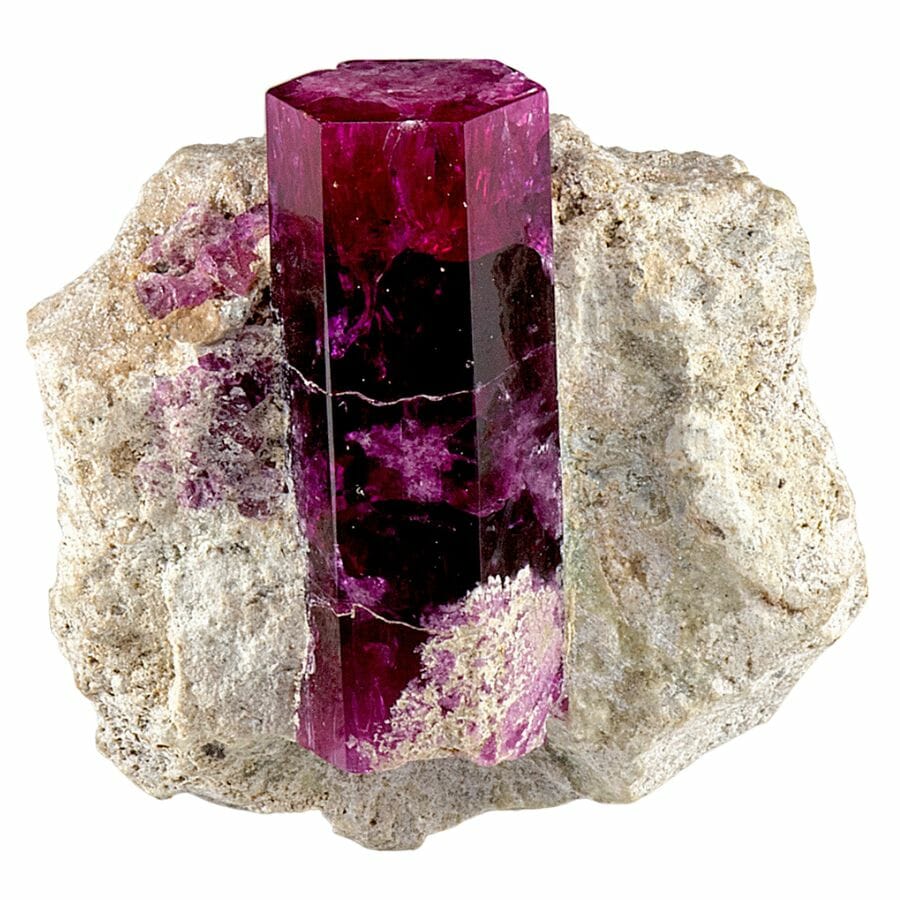 red beryl crystal with six sides on a matrix