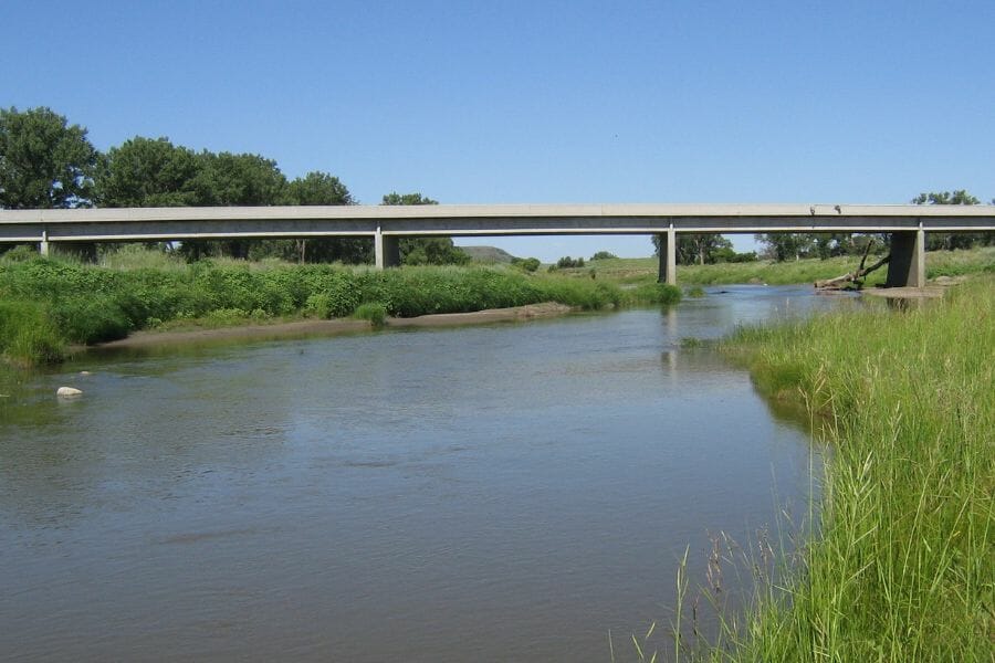 Cannonball River with grassy riverbanks and a concrete bridge