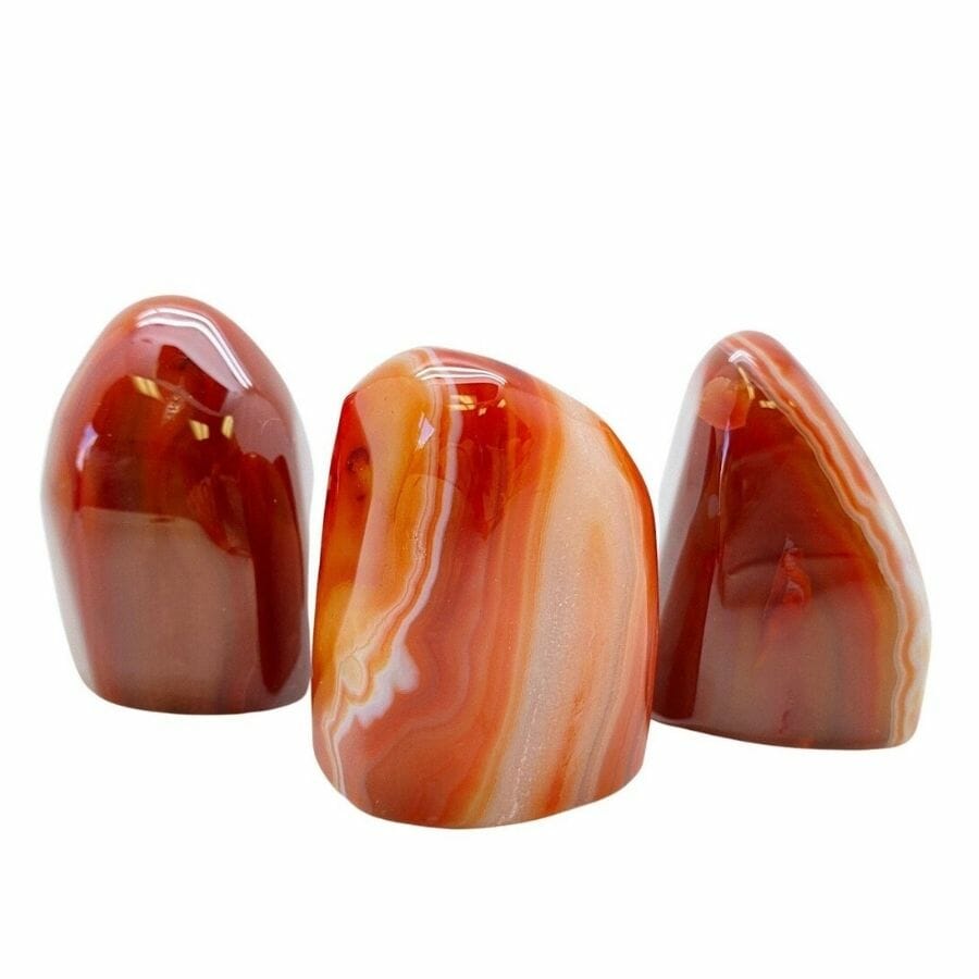 polished carnelian stones with red, orange, and white bands