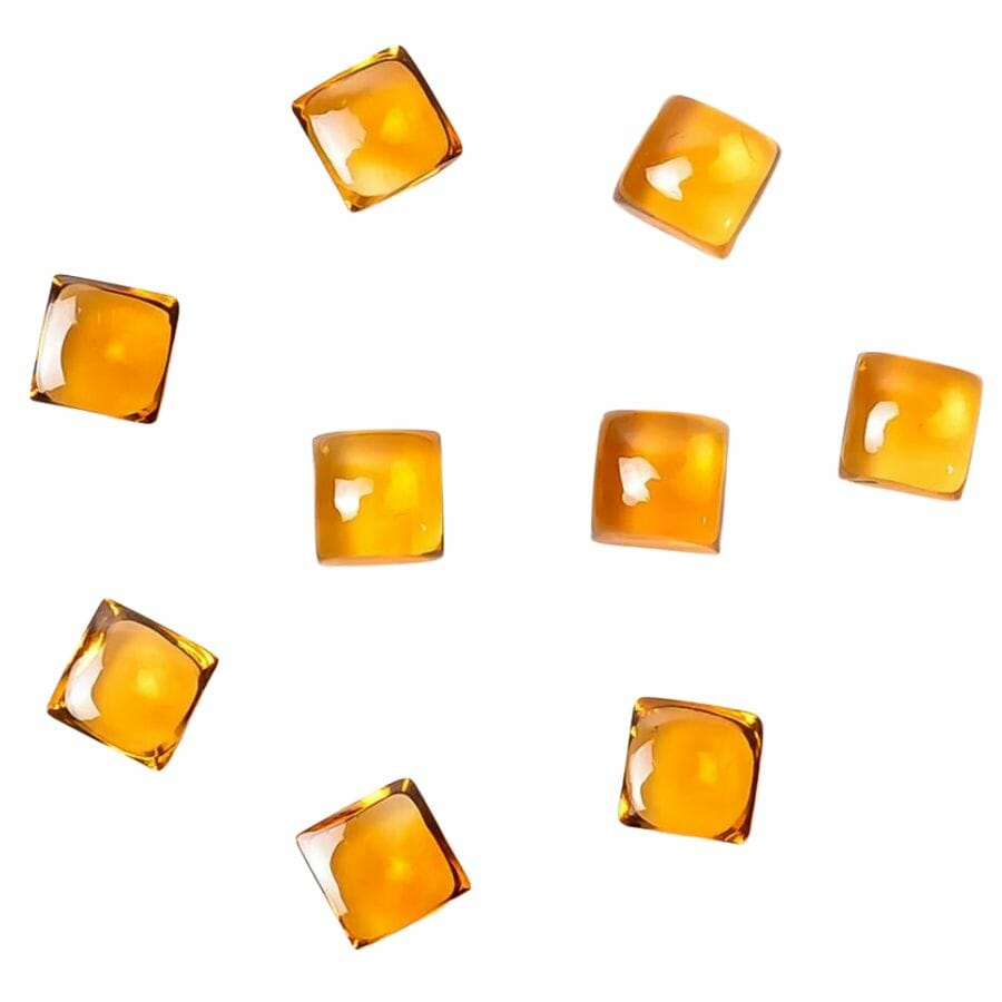 nine orange citrine cabochons showing full clarity and vitreous luster