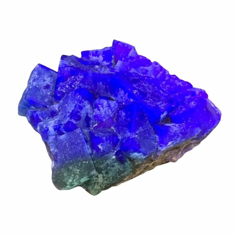green fluorite crystals glowing bright blue under UV light