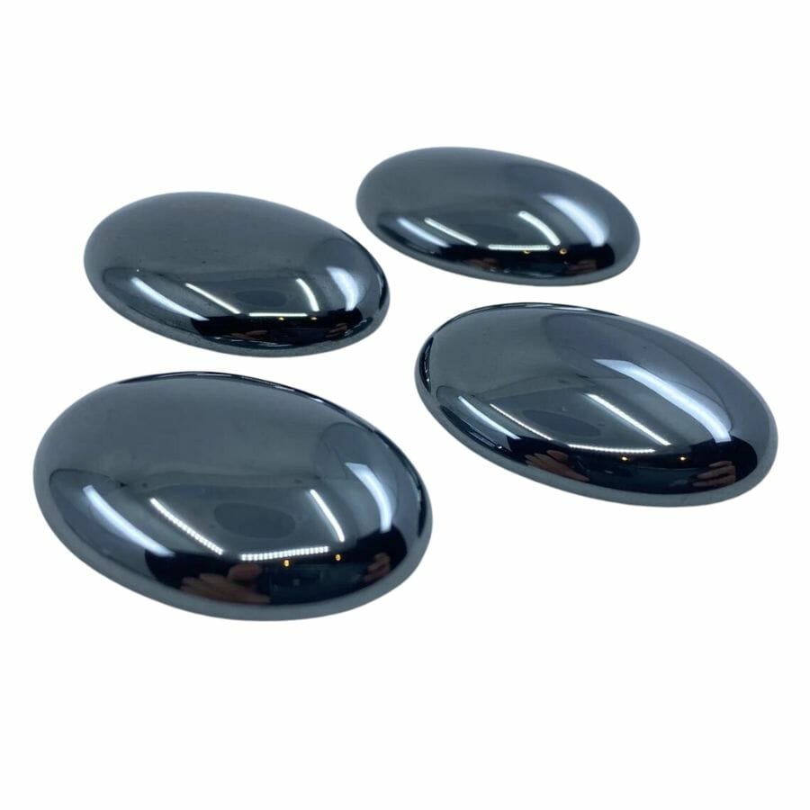 four black polished lustrous hematite cabochons