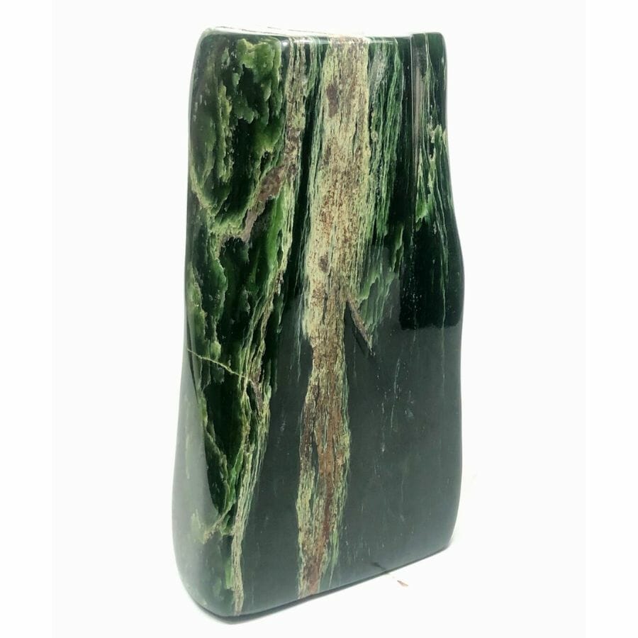 polished piece of deep green nephrite jade with white layers