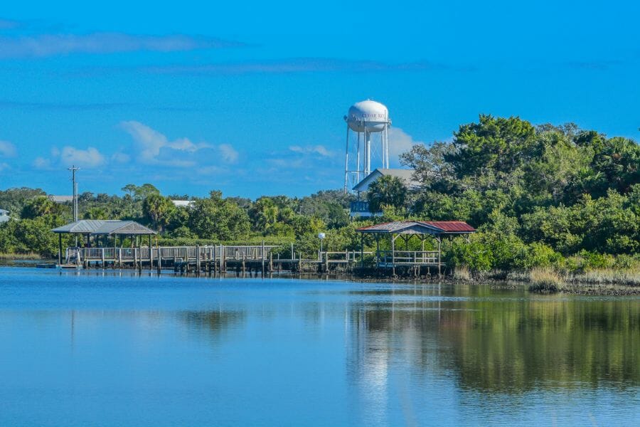 Levy County beach with docks  and a water tower in the background