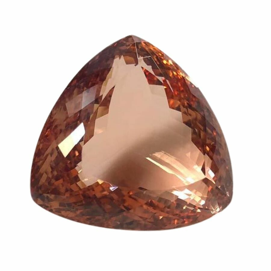 a piece of triangular morganite with a deep peach color