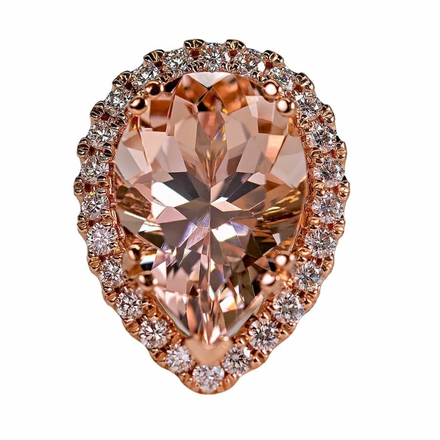 ring with peach-colored pear cut morganite center stone and diamond halo