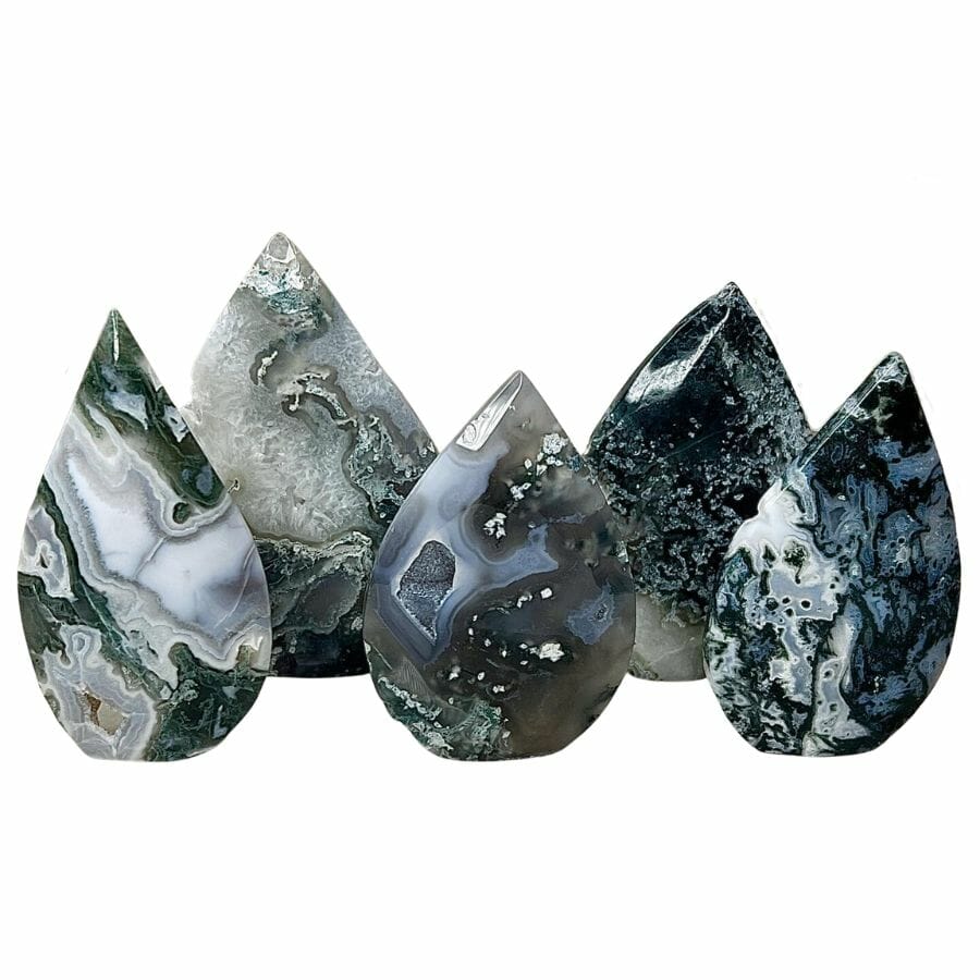 five moss agate flames with a semi-translucent to opaque base and dark green mossy patterns