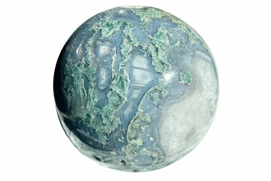 polished sphere of moss agate with translucent base and green mossy patterns