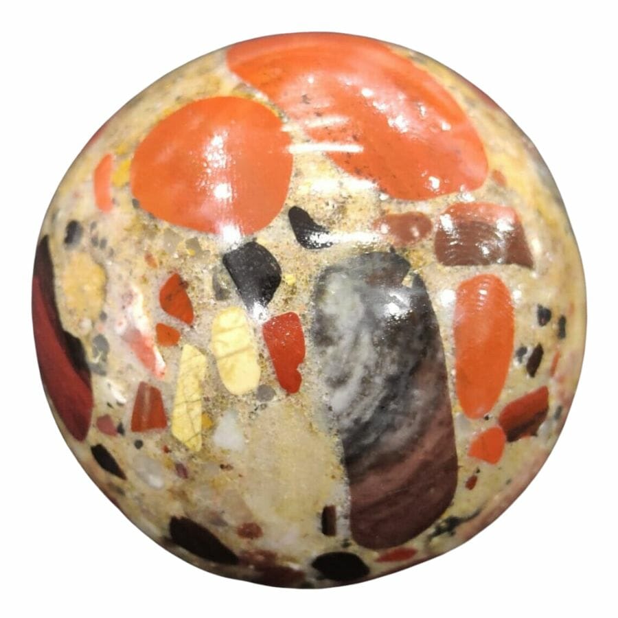 polished puddingstone sphere with orange, brown, and yellow stones