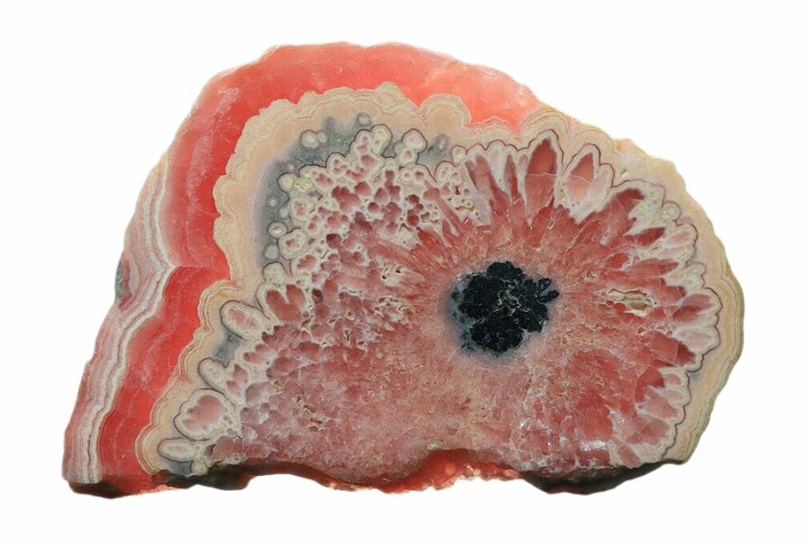 slab of rhodochrosite with pink, white, and black bands