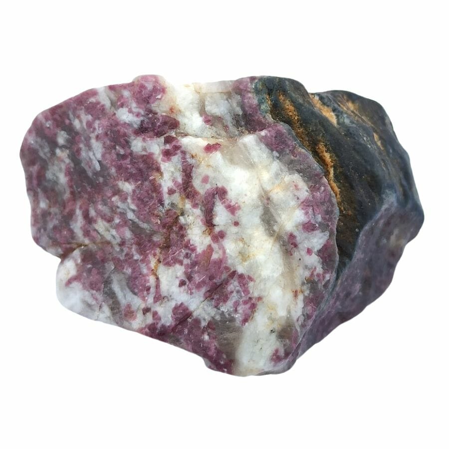 rough piece of rhodonite showing deep pink, white, and black layers