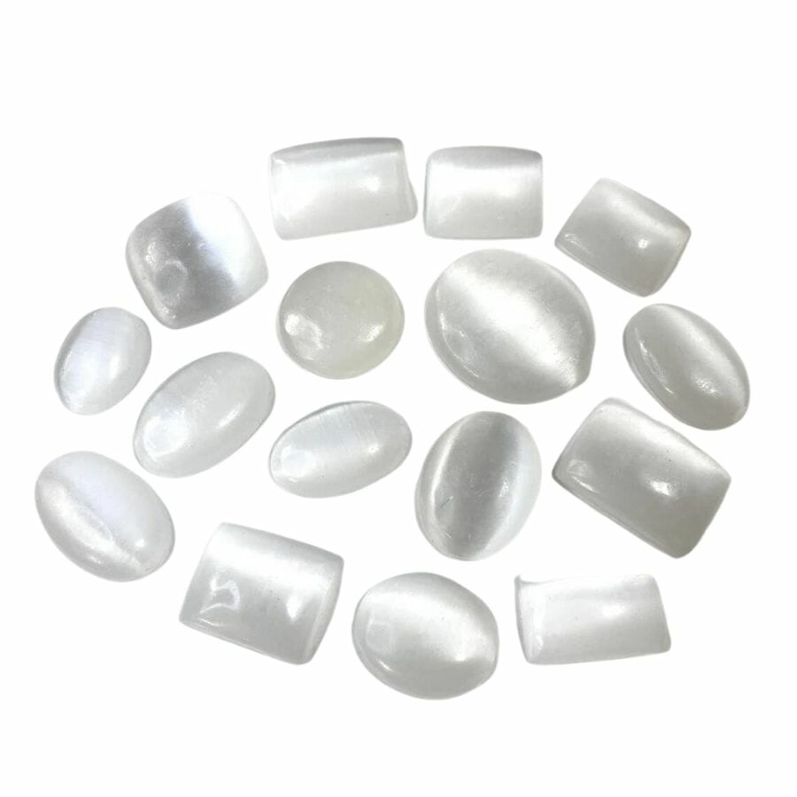 collection of oval, round, rectangular, and square selenite cabochons