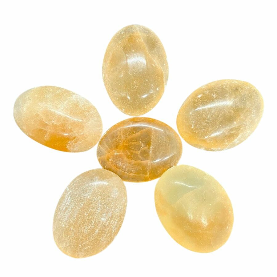 five oval peach selenite stones