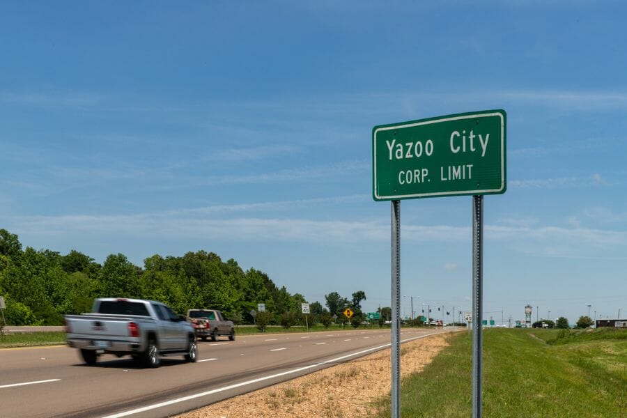 sign saying Yazoo City next to a cement road