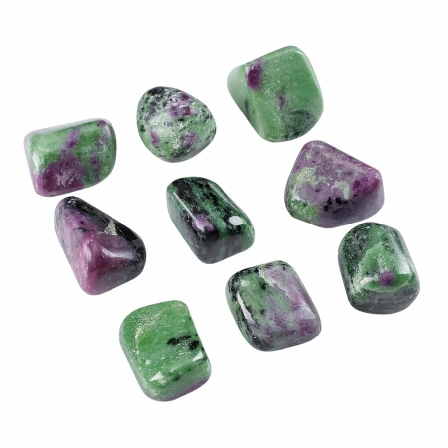 nine green polished zoisite stones with black and red-purple flecks