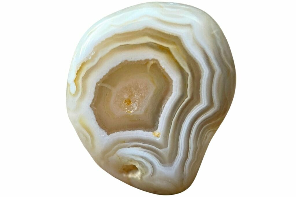 A cream-colored agate with geometric bands of white and brown
