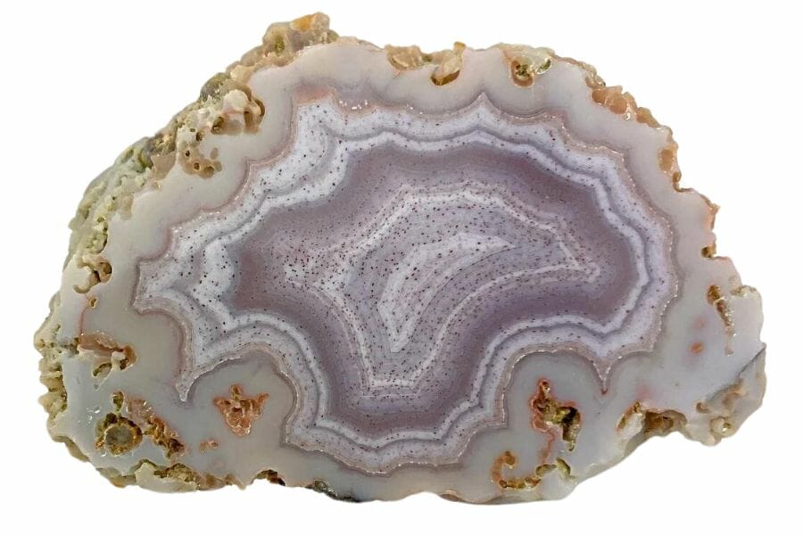 A mesmerizing agate crystal with purple and white bands at the center