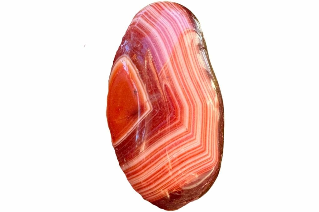 A shiny banded agate with bands of white, orange, and red
