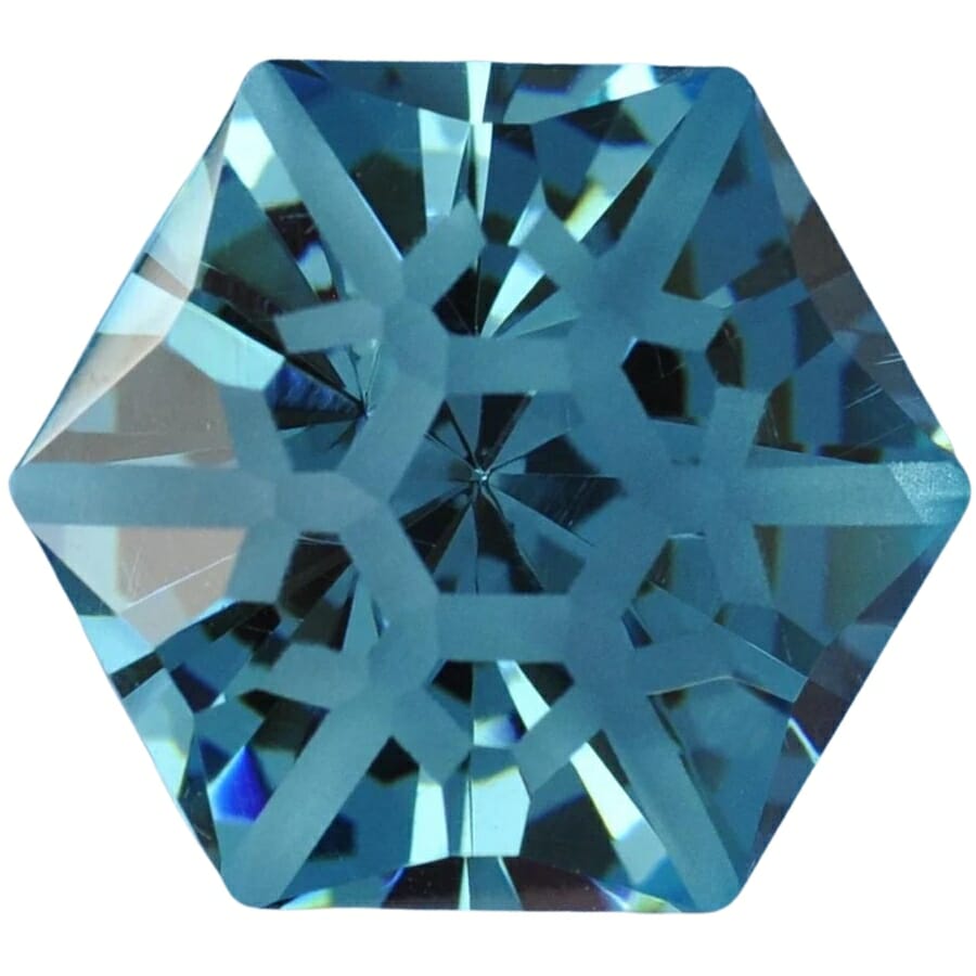A hexagon-shaped polished blue cubic zirconia crystal