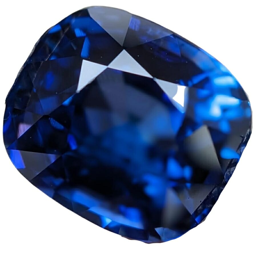 A shiny polished sapphire gemstone with crystal patterns inside