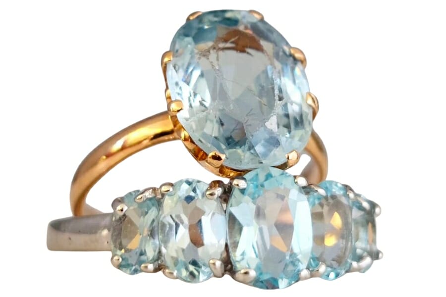 Sky blue topaz adorning gold and silver rings