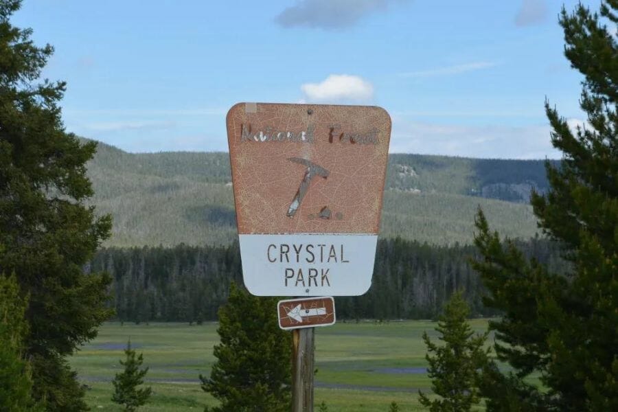 Crystal Park sign against a background of a mountain