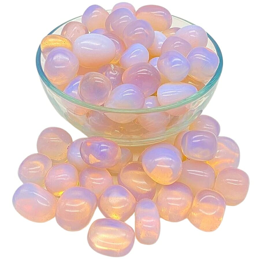 A bunch of polished opalites brimming from a transparent bowl