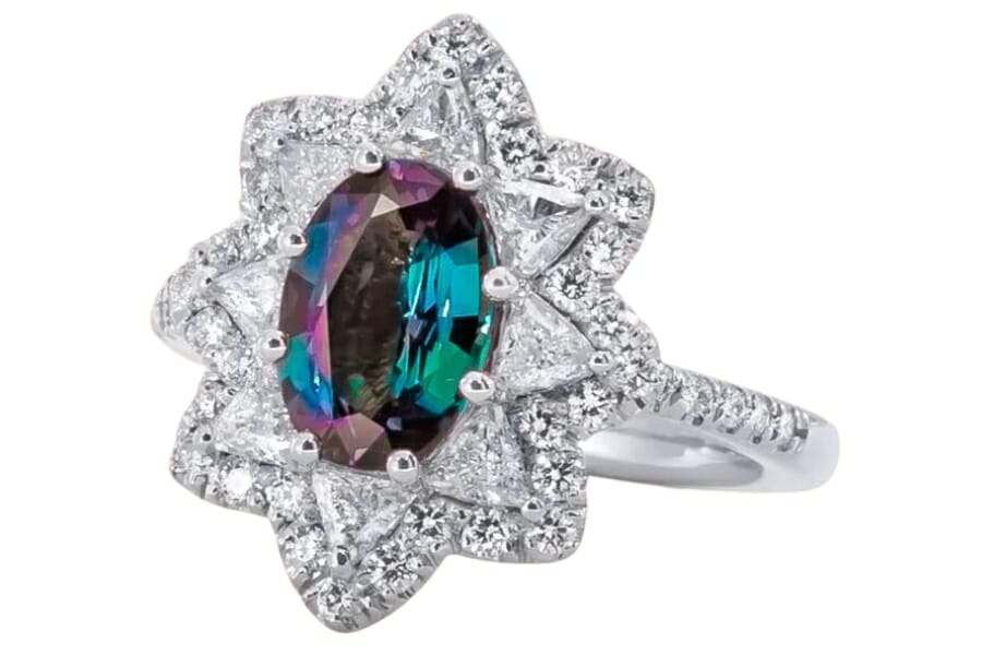 A luxurious flower-shaped ring with a multi-colored alexandrite gemstone at its center