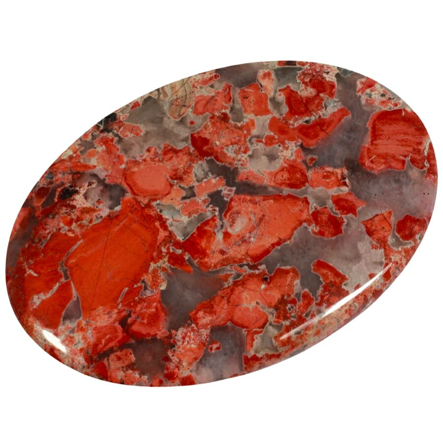 A poppy jasper palm stone with colors of brown and red