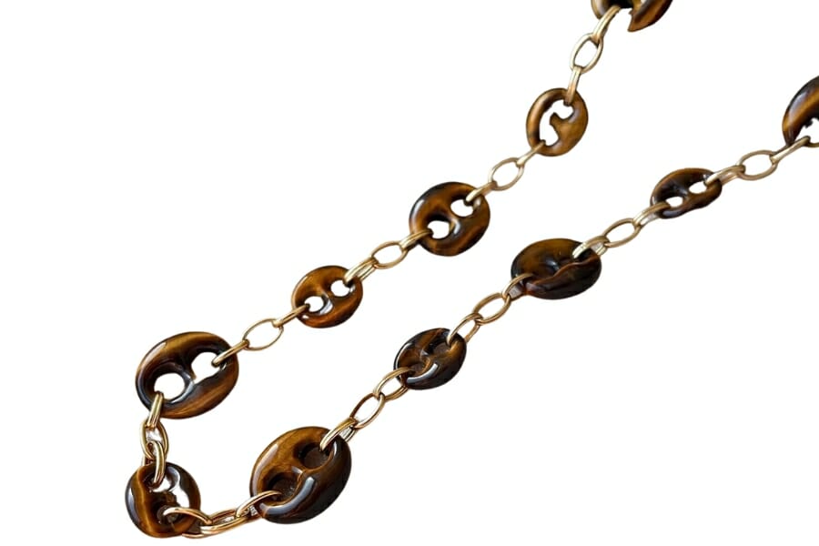 A unique gold tiger's eye button-like chain necklace