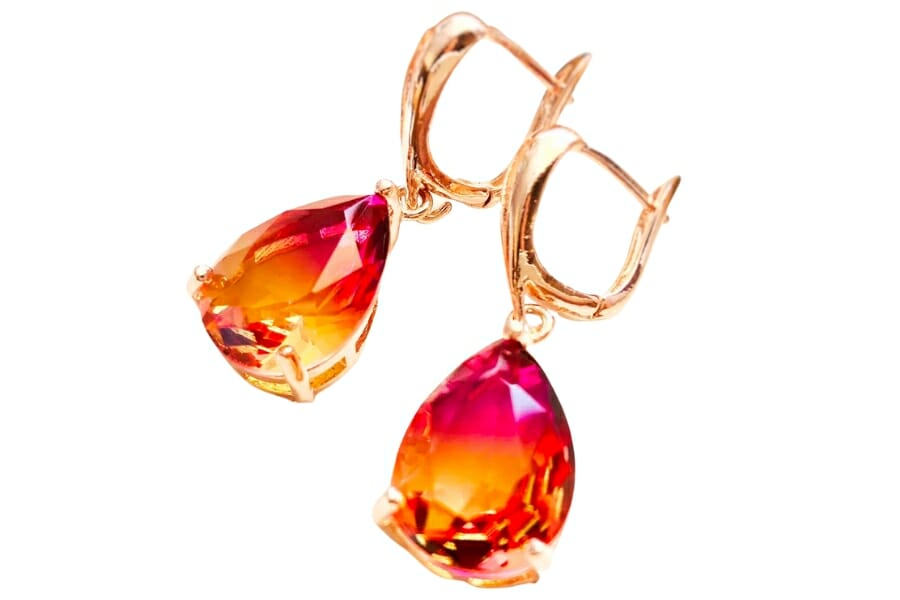 A pair of gold dangling earrings with beautiful bi-colored Imperial topaz