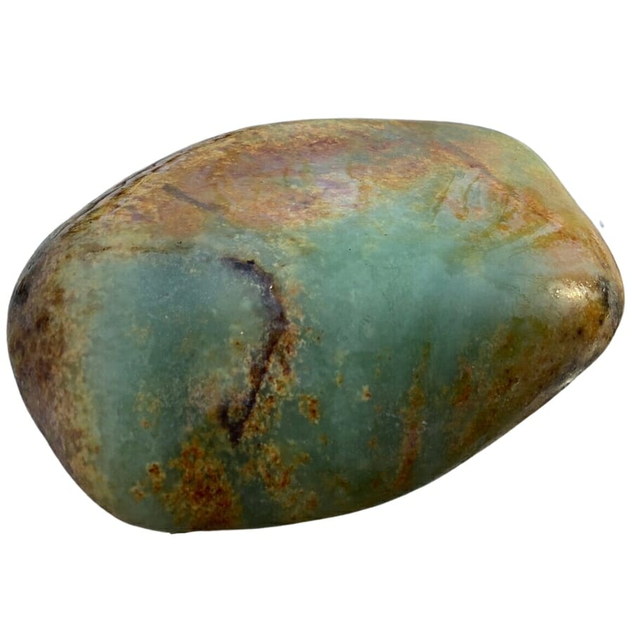 A tumbled jade stone with different hues of green and brown