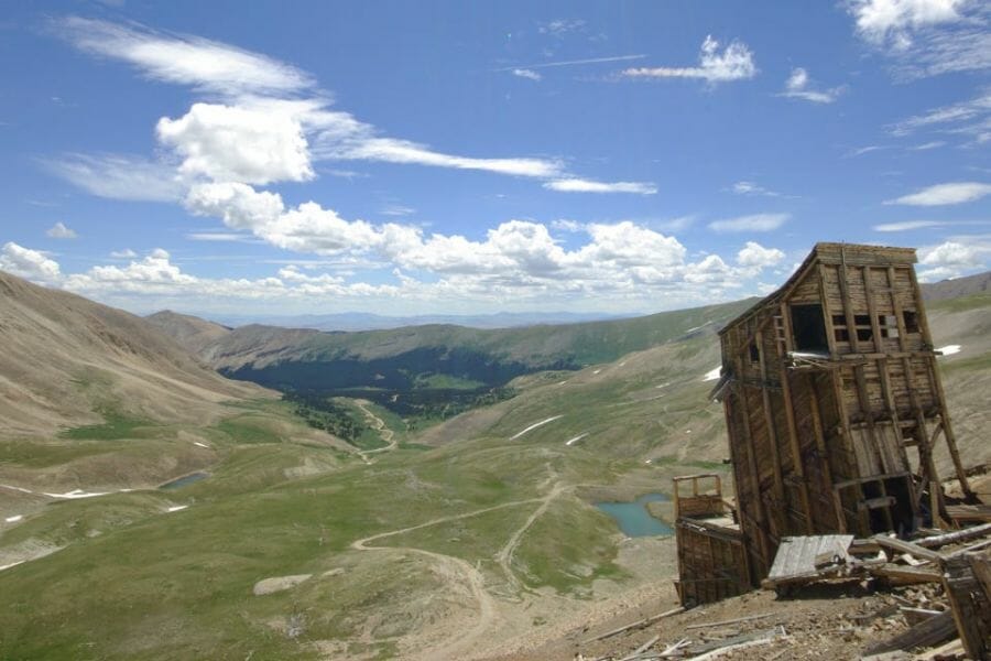 green hills and an old wooden structure