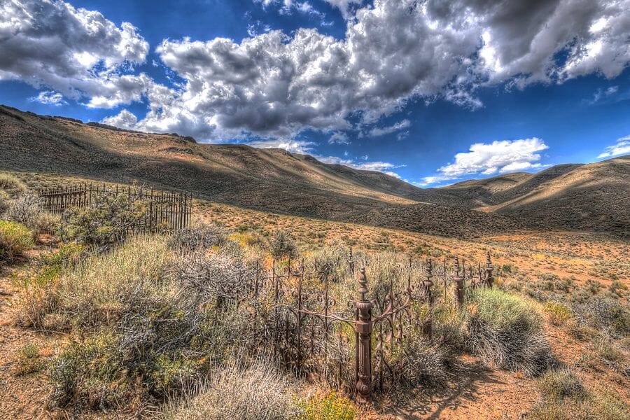 grassy slopes under a blue sky with clouds