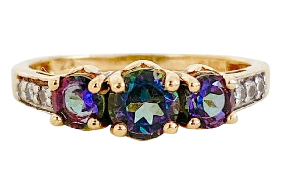 A gold ring adorned with three beautiful mystic topaz