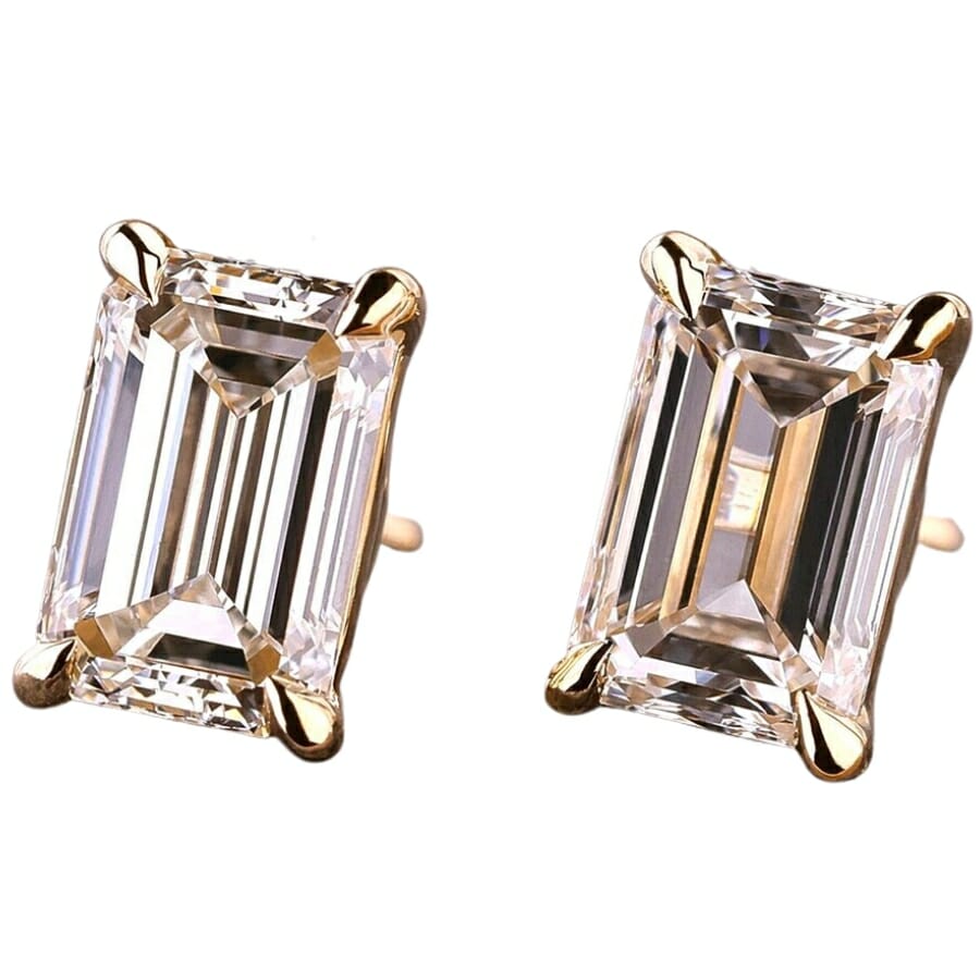 A pair of earrings with emerald cut white diamonds