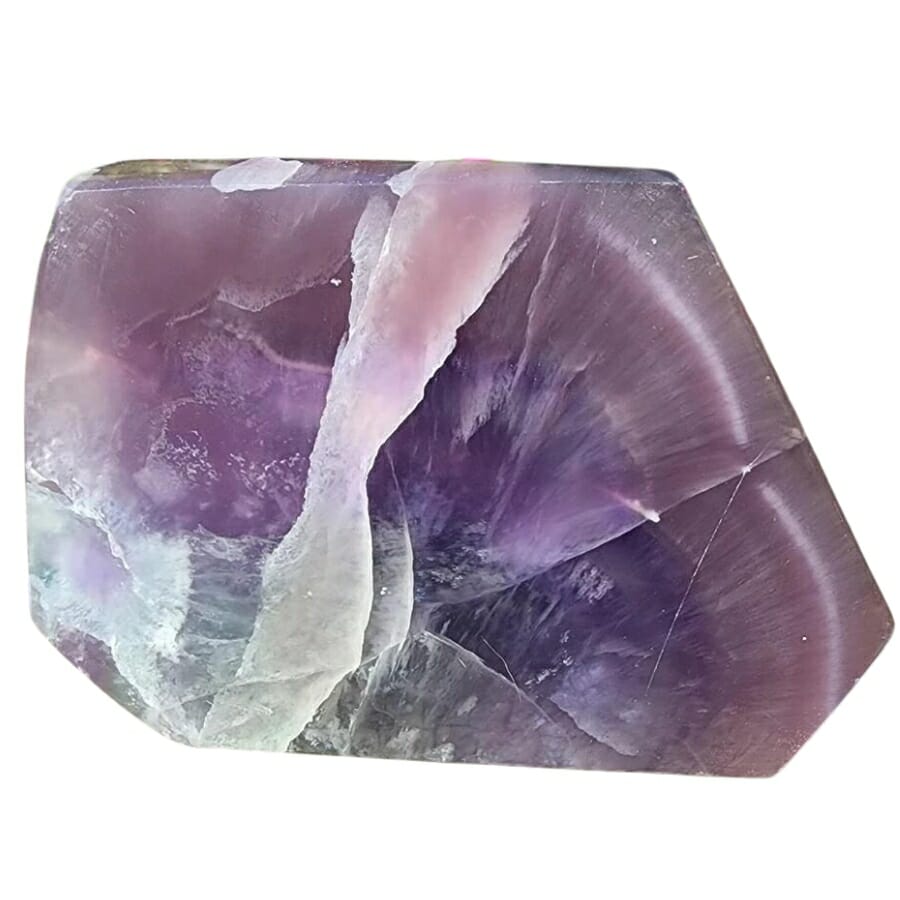 A big slab of raw purple fluorite with different lovely shades of purple and a white streak through the middle