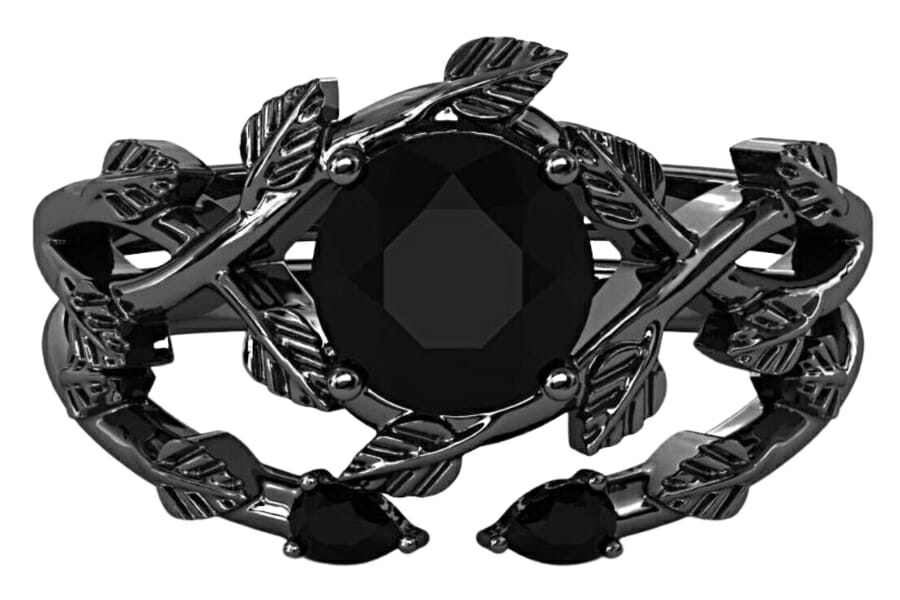 Intricately-designed ring with a black onyx center stone and leaf-designed rhodium sterling silver