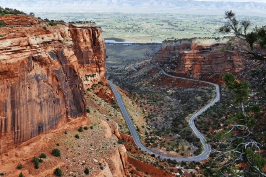 A scenic view of the Rim Rock Drive with majestic cliffs and vast landscape