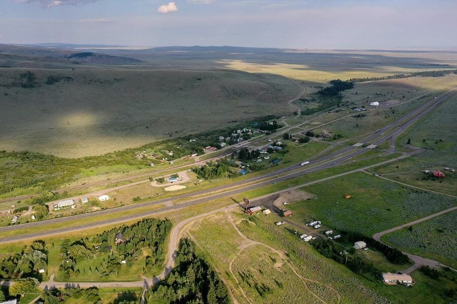 aerial view of Spencer, Idaho, with green fields and some buildings