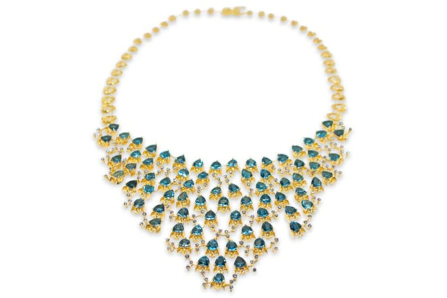 Vibrant blue pieces of topaz in a gold necklace