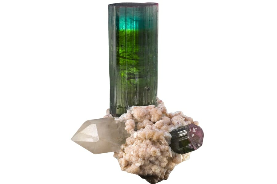 A multi-colored cylindrical tourmaline crystal with inclusions