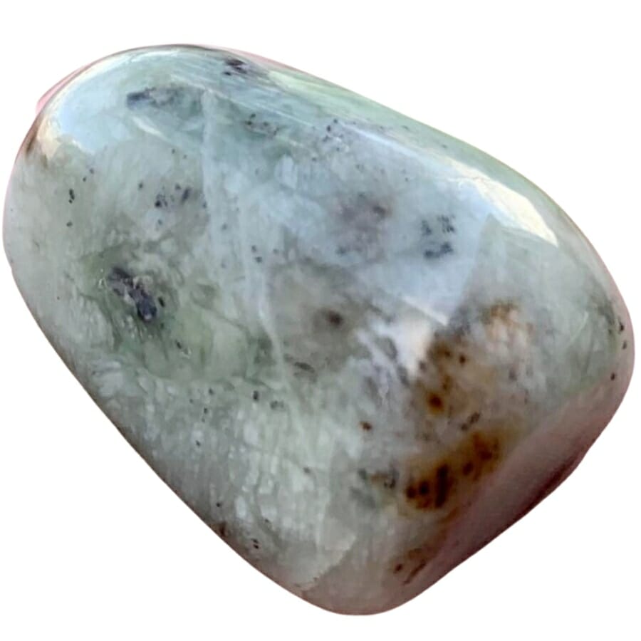 A wonderful tumbled serpentine jade with black spots and a white color